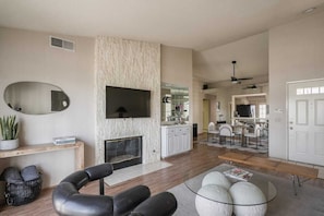 Smart TV, fireplace, books, printers