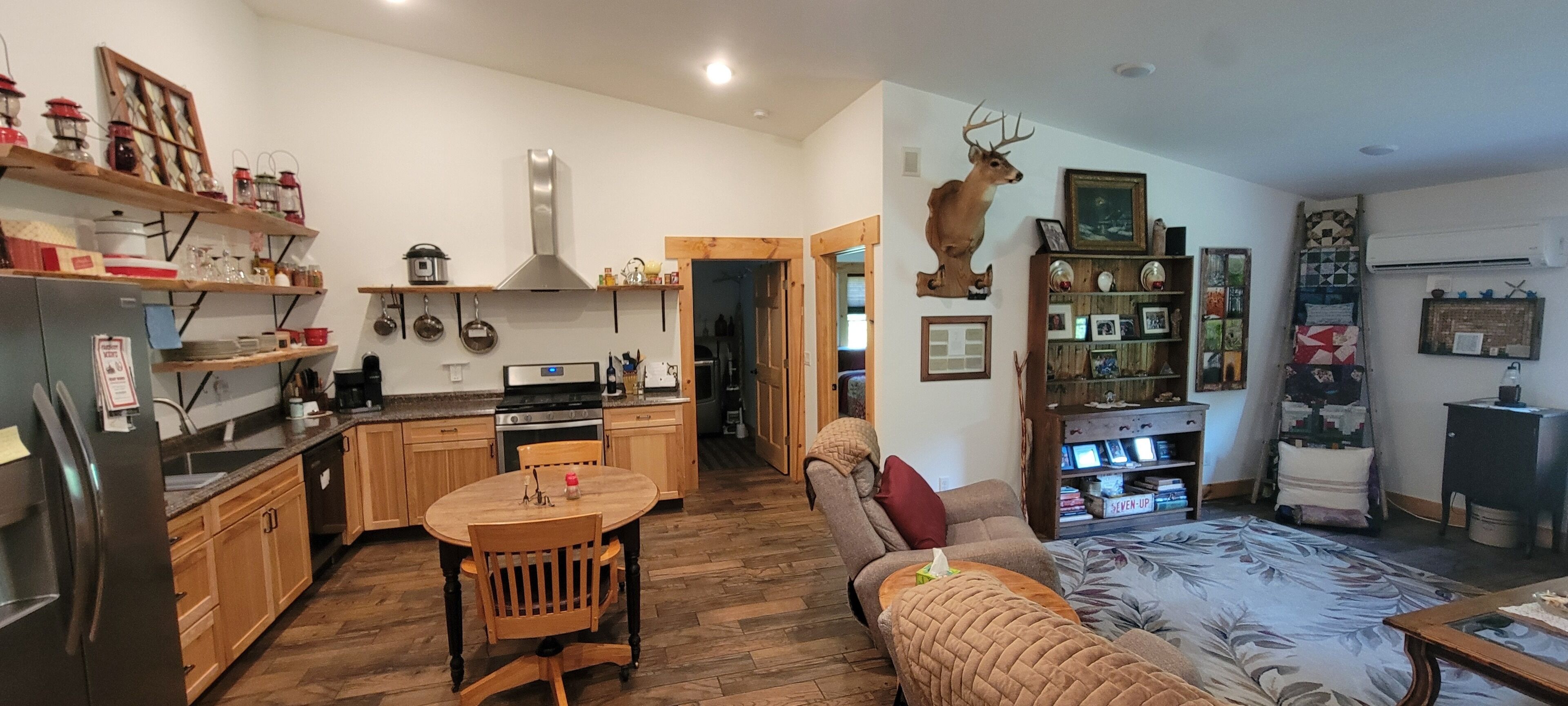 A compact living space with a kitchen, dining area, and a cozy seating area.