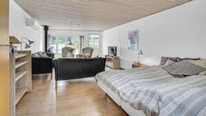 Ein Schlafzimmer mit Bett, Schreibtisch, Stuhl und Fernseher.