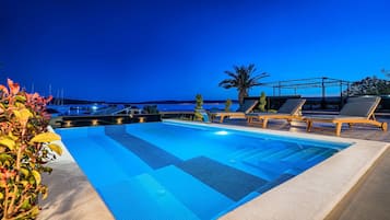 Outdoor pool, a heated pool, sun loungers