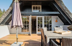 Relax in a tranquil outdoor patio area with a comfortable seating space and easy access to the main house.