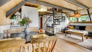 A spacious loft with a high ceiling, wooden beams, a staircase, and a cozy seating area with a sofa and coffee table. - Nice home in Løgstrup with WiFi (Løgstrup)