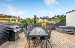 Enjoy al fresco dining on the rooftop deck with a grill and seating for six.