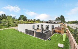 Enjoy a spacious backyard with a well-maintained lawn and a play area for kids.