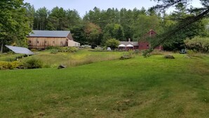 A rural property with a large wooden barn, a red house, and a greenhouse. - Fabulous, restful, studio with AC in charming Hopkinton (Hopkinton)