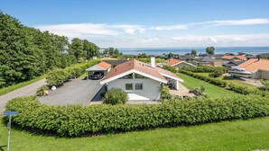 A residential area with houses, a driveway, and a view of the sea. - Pet friendly home in Sjølund with sauna (Sjølund)