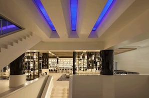 A modern interior with a staircase, seating area, and a bar. - W Hotel - Beachfront 2 bedroom oasis (Fort Lauderdale)