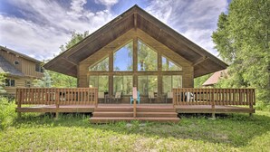 A large wooden cabin with a prominent gable roof and large windows. - 'The River Home' Cabin w/ Yard: Near Wolf Creek! (Pagosa Springs)