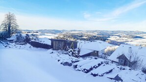 A snow-covered landscape with houses and a clear sky.