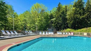 A swimming pool with lounge chairs and a small building in the background. - Winter ‘27 Seasonal Available-Dog Friendly Chalet in the Woods + Pool, Mt. Snow (Wilmington)