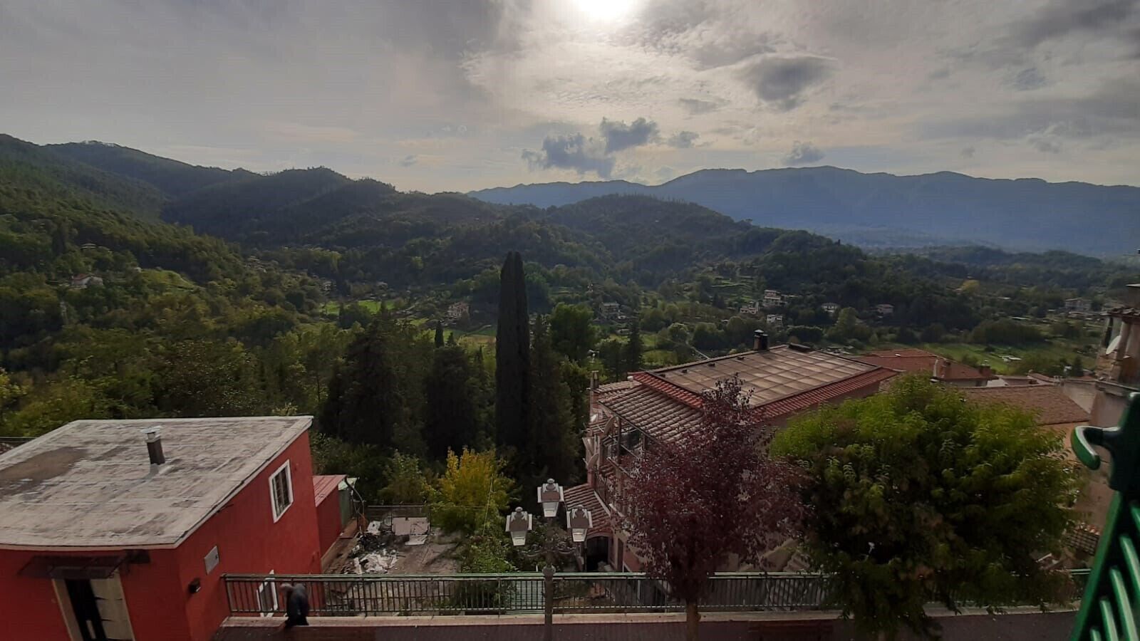 A view of a mountainous landscape with a church and residential buildings.