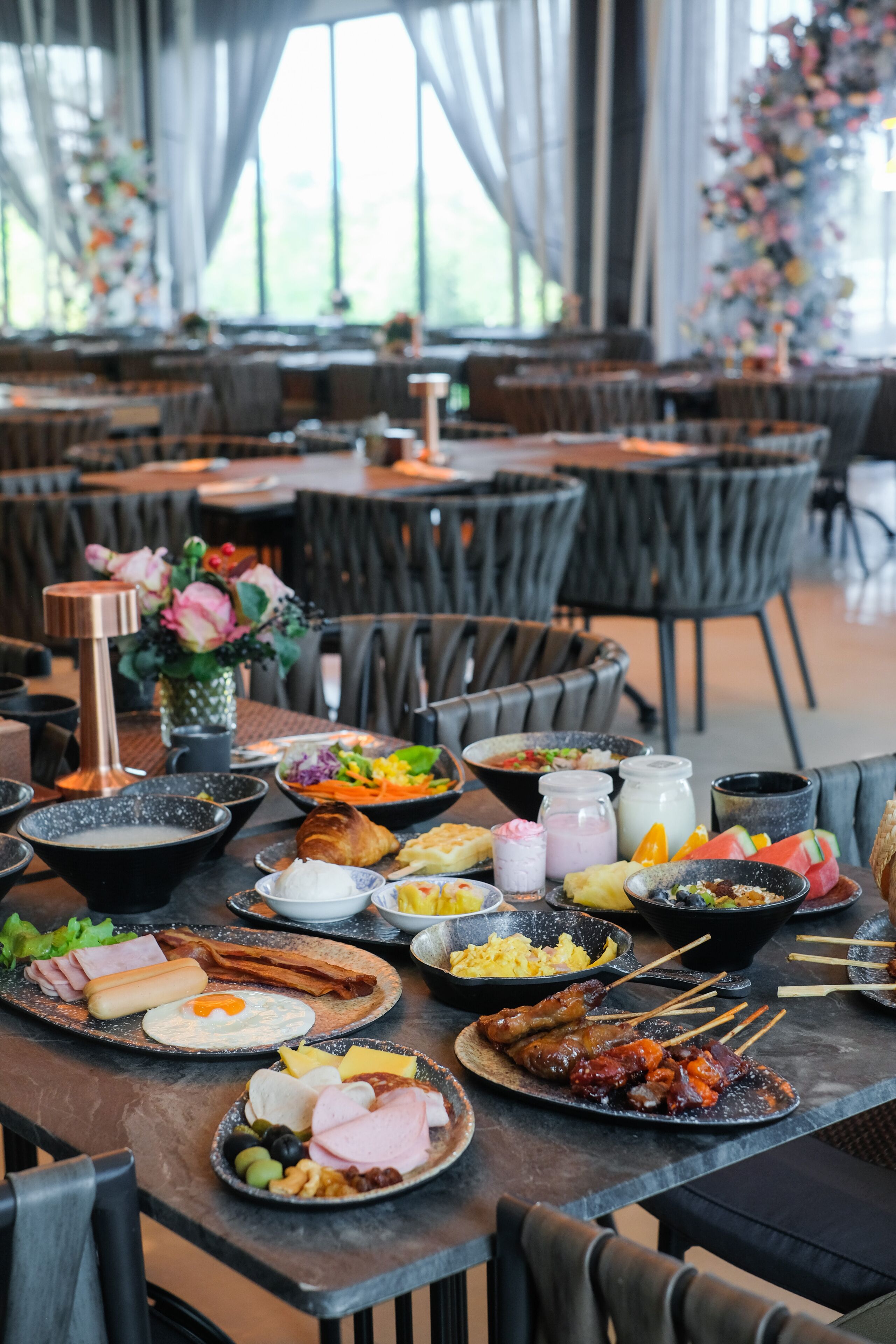 A dining table with various dishes, including eggs, meats, and vegetables.