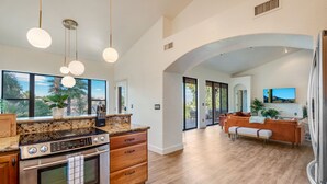 A spacious kitchen with granite countertops, a stainless steel oven, and pendant lighting. - Amazing Peaceful Resort - Heated Pool, Hot Tub (Fountain Hills)