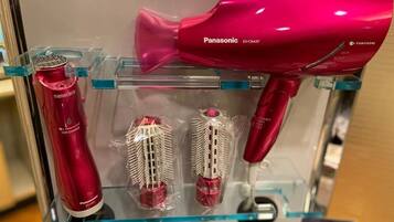 A Panasonic hair dryer and two hairbrushes on display.