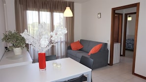 Relax in this stylish living room with a sofa, table, and candles.
