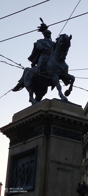 A statue of a person on horseback, mounted on a pedestal with inscriptions.