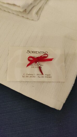 A business card for Sorrentino with contact details and address.