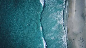 An aerial view of a beach with waves crashing onto the shore. - Ti Baz Beach House With Mountain View (Tamarin)