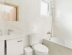 A modern bathroom with a toilet, sink, and bathtub. - Sanders White Mountains - Charming Villa With Pool (Tremithousa)