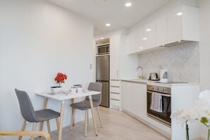 Enjoy meals in the kitchen with a dining area and modern appliances.