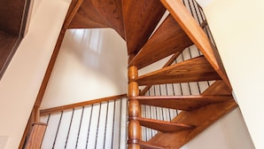 A wooden spiral staircase with a handrail and a metal railing. - Harbour Views Gozitan Villa + Shared Pool (Ghajnsielem)