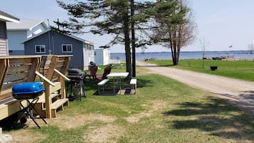 Enjoy lakeside dining and relaxation on the deck with a barbecue grill and seating area.