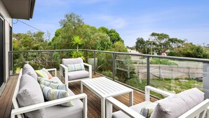 A balcony with a sofa, chairs, and a table. - Aireys Delight (Aireys Inlet)