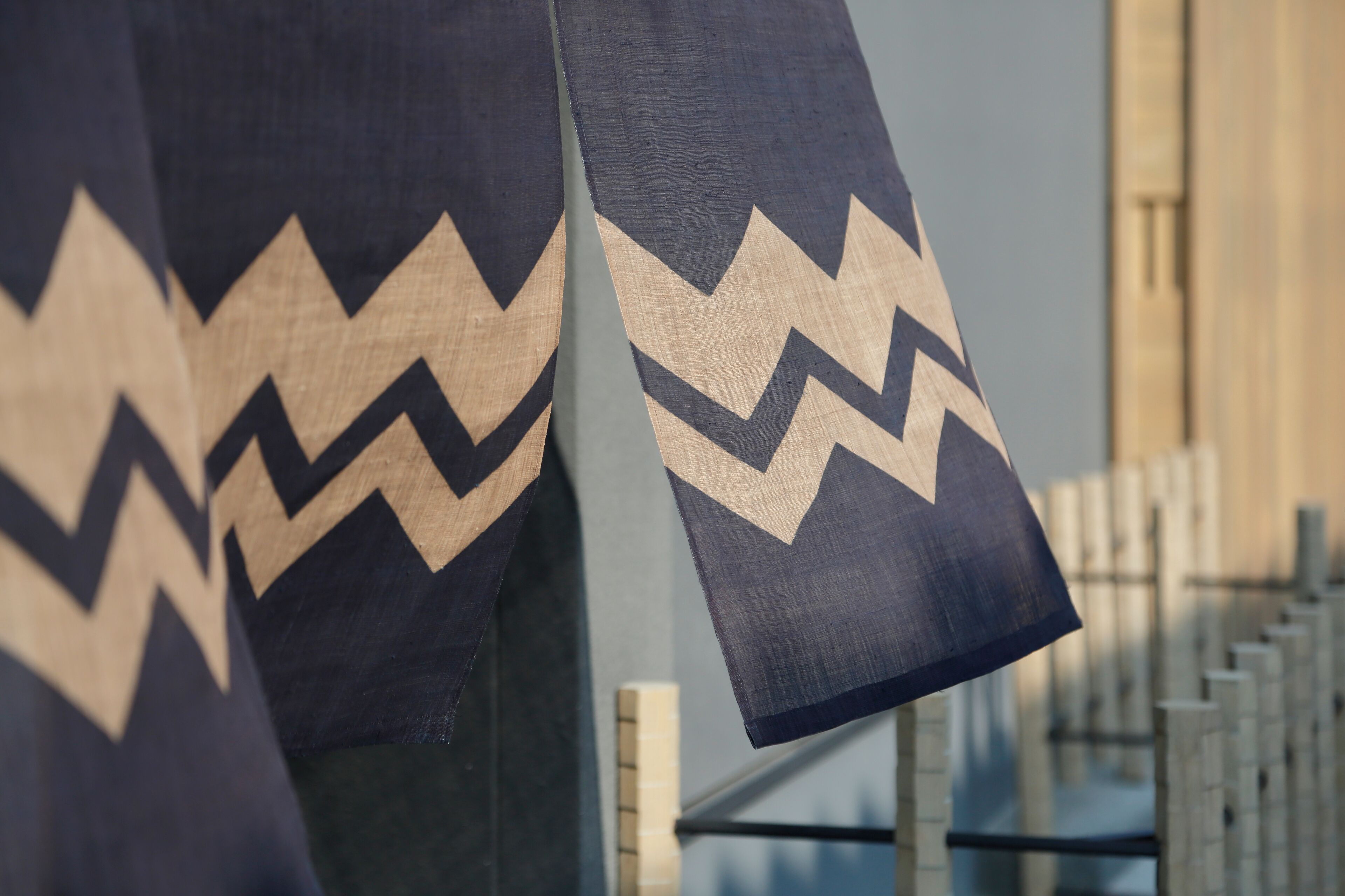 A close-up of a patterned fabric with zigzag designs, likely part of a larger textile or garment.