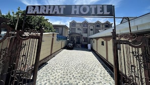 The entrance to Barhat Hotel with a tiled pathway leading to the main building. - BARHAT HOTEL (Tashkent)