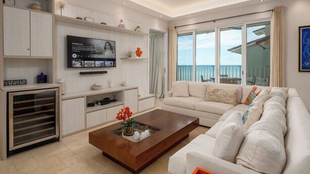 A modern living room with a large TV, a sofa, and a coffee table. - Charming Beachfront 3BR in Puntarena (Río Hato)