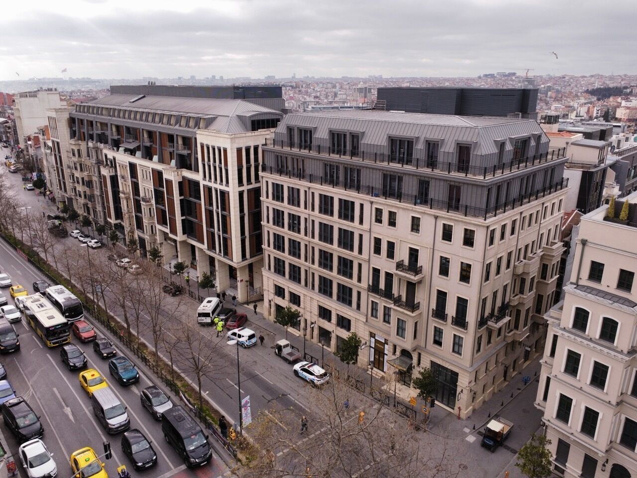 A multi-story building with a modern architectural design, featuring balconies and large windows.