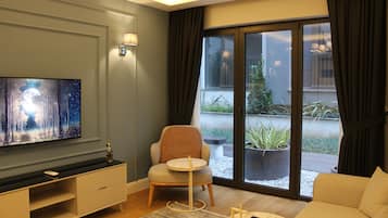 GR1 Block Garden Apartment | Living area | 55-inch Smart TV with satellite channels, TV, heated floors