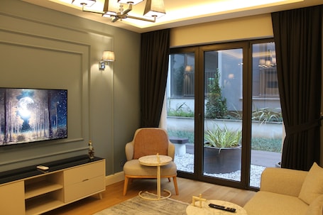 GR1 Block Garden Apartment | Living area | 55-inch Smart TV with satellite channels, TV, heated floors