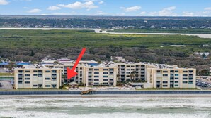 A multi-story hotel with a pool area and a view of the surrounding landscape. - Castle Reef 123 beautiful beachfront condo! (New Smyrna Beach)