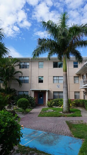 A multi-story building with a blue door and a sign reading "BLDG 700".