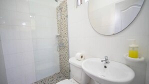 A bathroom with a toilet, sink, and shower. - Fully Equipped 1BR Studio ->DT->2Mins to the Beach (sosua)