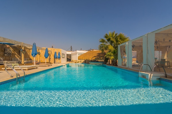 Outdoor pool, pool umbrellas, sun loungers