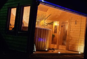 Un edificio de madera con porche, puerta y ventana.