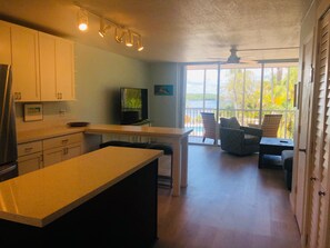 Enjoy a meal in the kitchen with a central island, dining area, and large windows offering a view of the surrounding landscape.