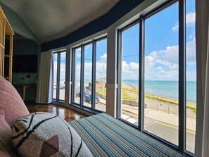 A room with large windows overlooking a marina and beach. - King Sitric (Dublin)