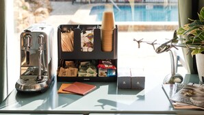 Eine Küchenarbeitsplatte mit Kaffeemaschine, Tassenhalter, Notizbuch und Taschentuchbox.