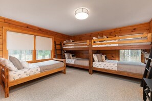 A cabin with three bunk beds, a window with blinds, and a ceiling light. - Family&Pet Friendly*SLOPE SIDE*Fireplace*Stylish (Bartlett)