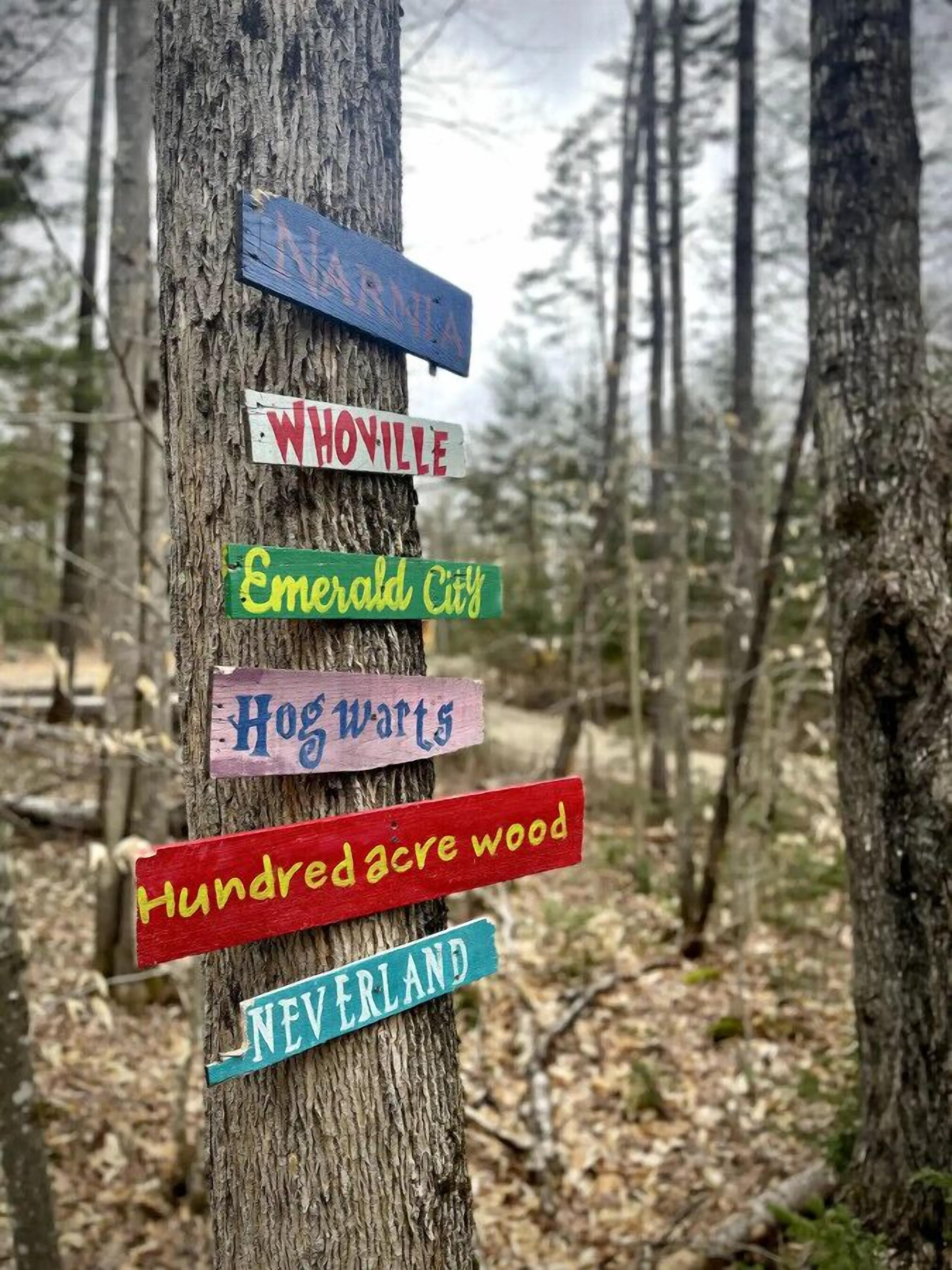 A wooden signpost with multiple directional signs.
