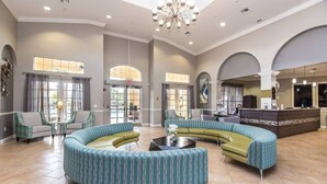 A spacious lobby with a curved seating area, a reception desk, and large windows allowing natural light. - Spacious and Modern Townhome! Close to Attractions and Conventions Center! 3vc5014-10 (Orlando)