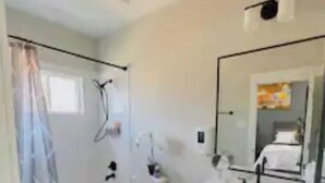 A bathroom with a toilet, sink, and shower. - Gray Lux Hse 3BR|3.5Bath~Downtown|MedCenter|HotTub (Houston)