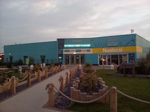 A building with a sign for 'Nisaland' and 'Entertainment Complex'. - River Views Dog Friendly Caravan 3 Bedrooms (Rye)