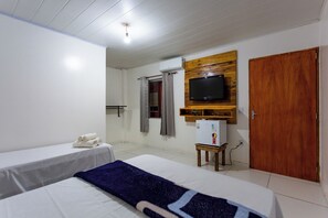 A hotel room with two beds, a television mounted on a wooden panel, a small refrigerator, and a wooden wardrobe. - Pousada Salomé (Bonito)