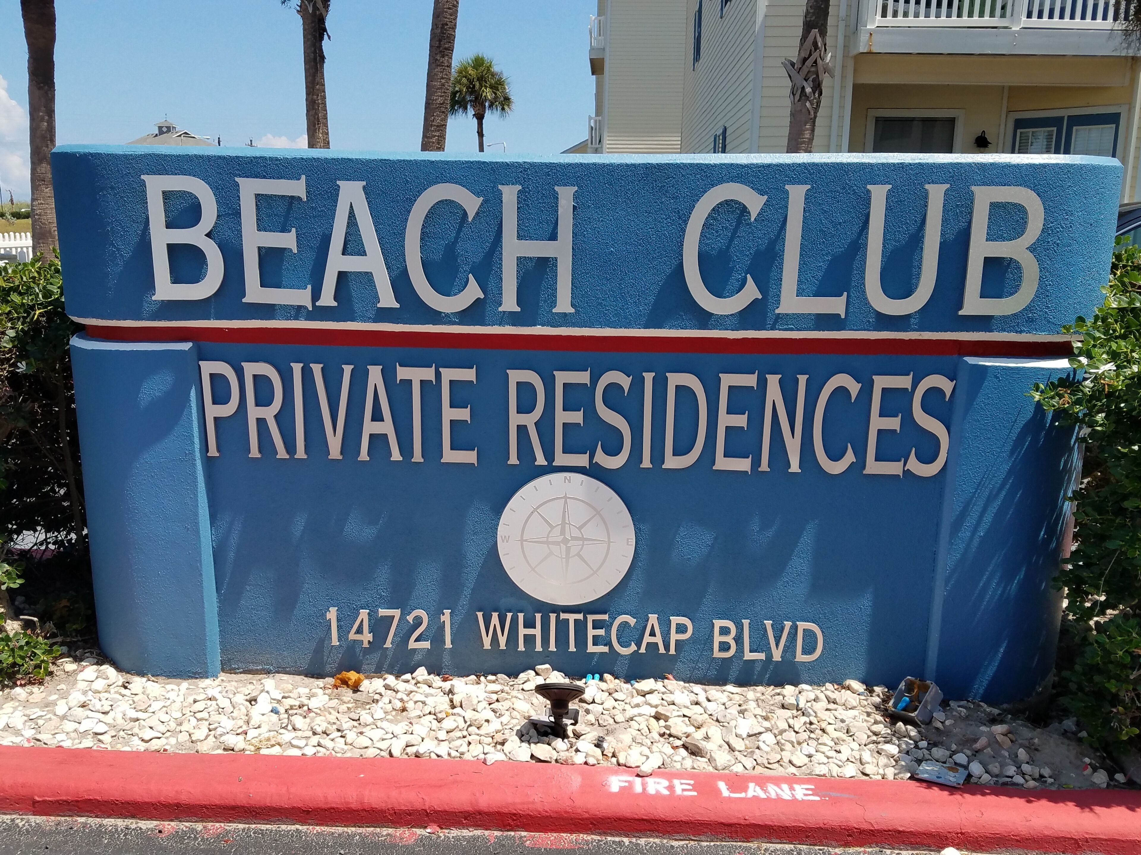 A sign for Beach Club Private Residences at 14721 Whitecap Blvd.