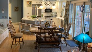 A dining area with a wooden table and chairs, a chandelier, and a view into the kitchen. - Nearly 6000 sq ft of luxury living only 3 mi from PSU stadium (State College)