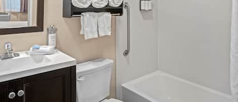 A bathroom with a toilet, sink, and bathtub.